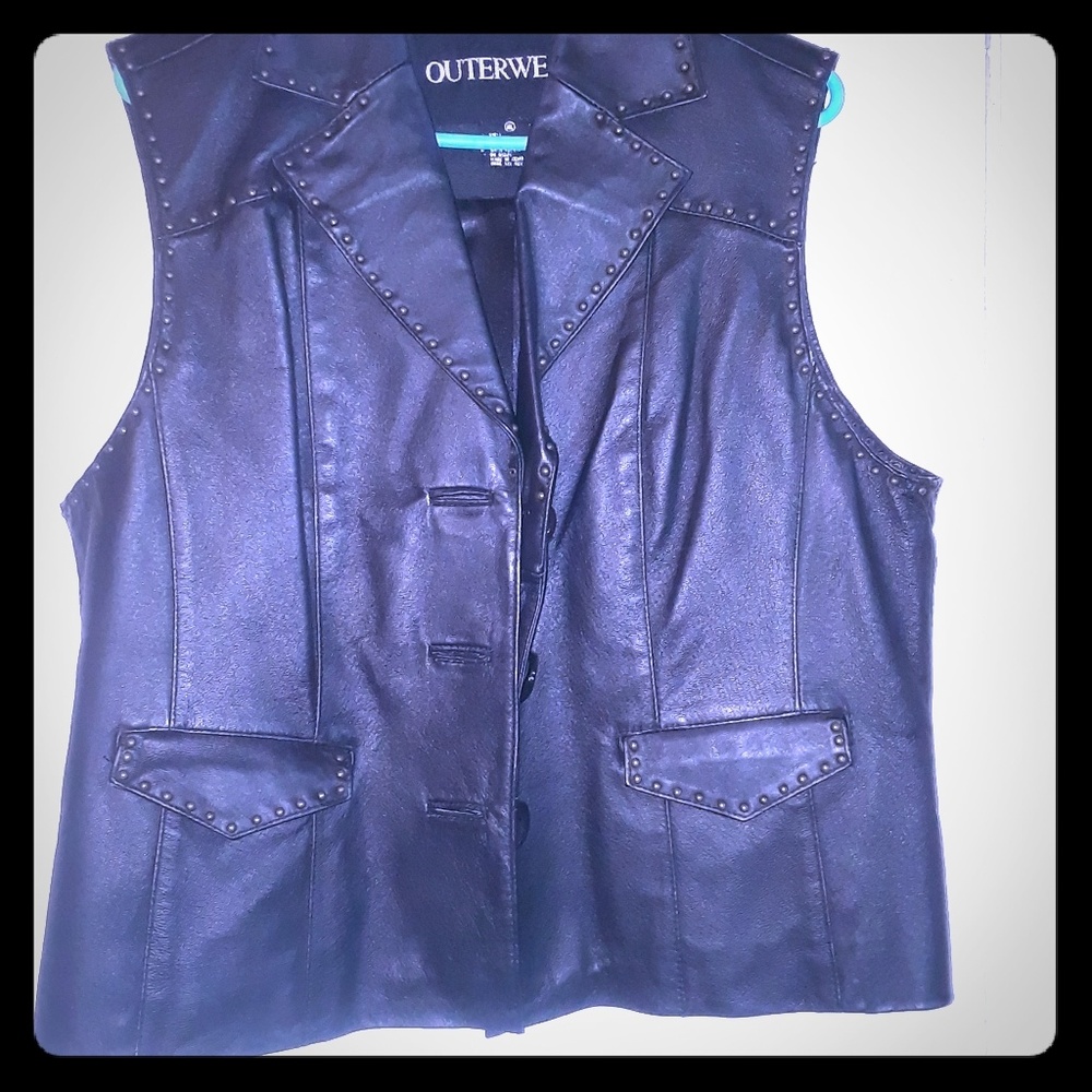 This is a ladies black leather vest